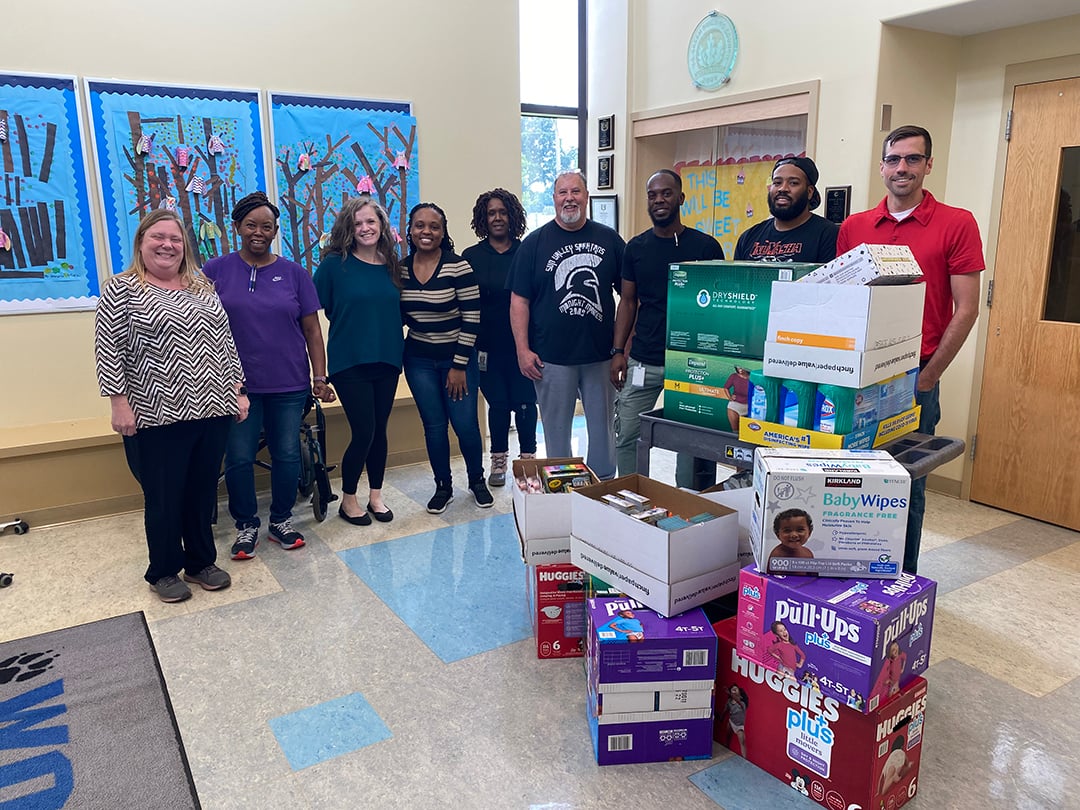 Monroe committee members drop off boxes of school and personal supplies to staff members of the Wolfe School